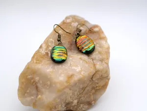 Dichroic rainbow stripes fused glass pierced dangling earrings on antiqued brass tone french wires. Approx 1.5 inches total length