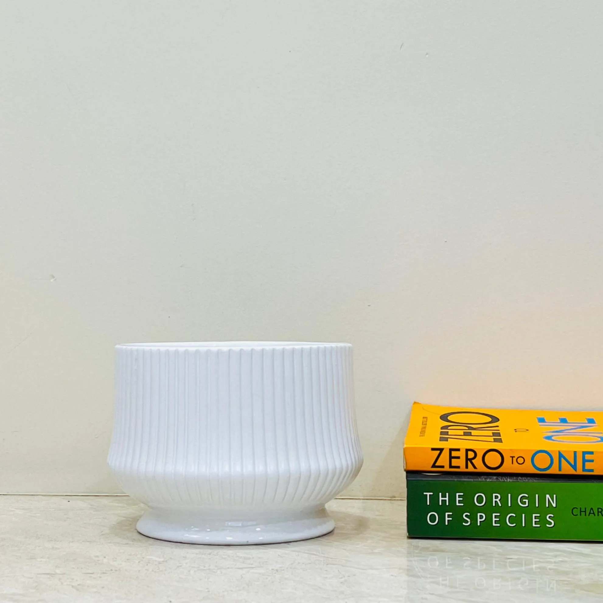 Glossy white ceramic pot with ribbed design