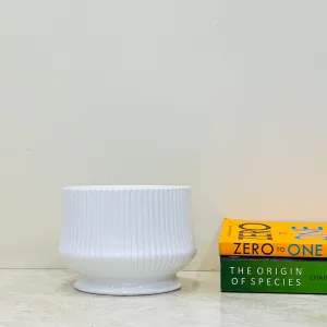 Glossy white ceramic pot with ribbed design