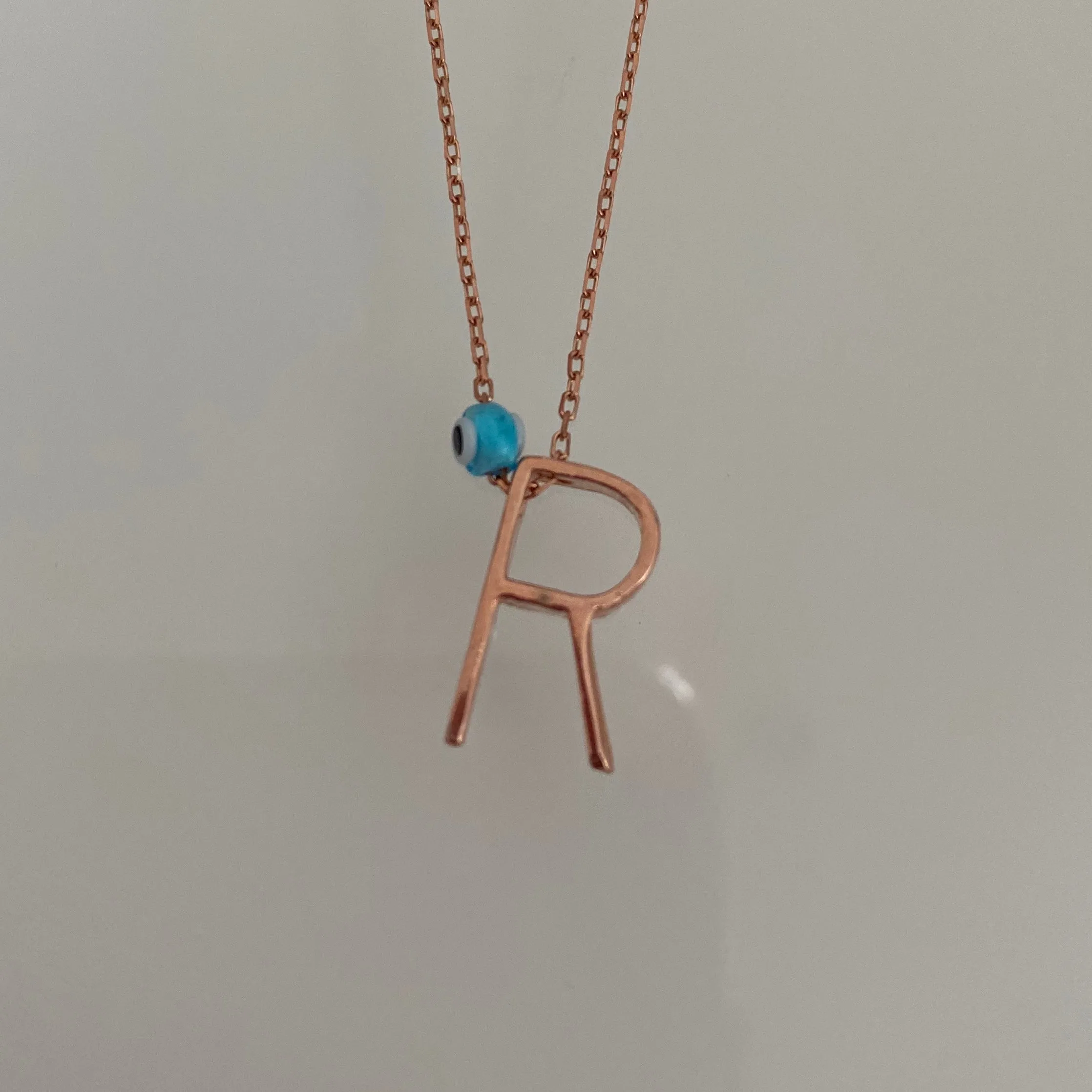 Minimalist letters with evil eye charm